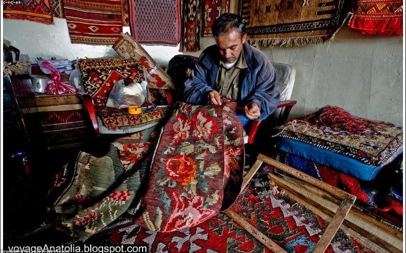 Artisan restoring antique rug by hand